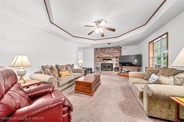 3009 Shadow Lake Dr, Greenwood, AR 72936 - carpeted living area featuring a ceiling fan, a textured ceiling, a brick fireplace, and a tray ceiling