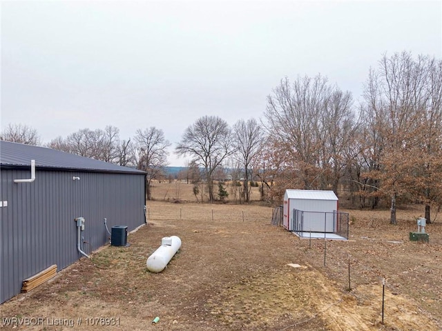 view of yard with cooling unit and a storage shed