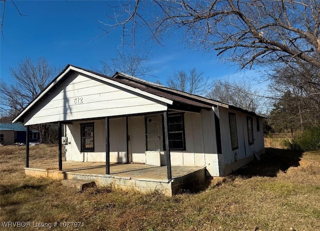 view of front of property with covered porch and a front yard