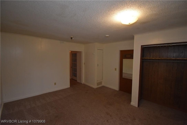 unfurnished bedroom featuring carpet floors and a textured ceiling