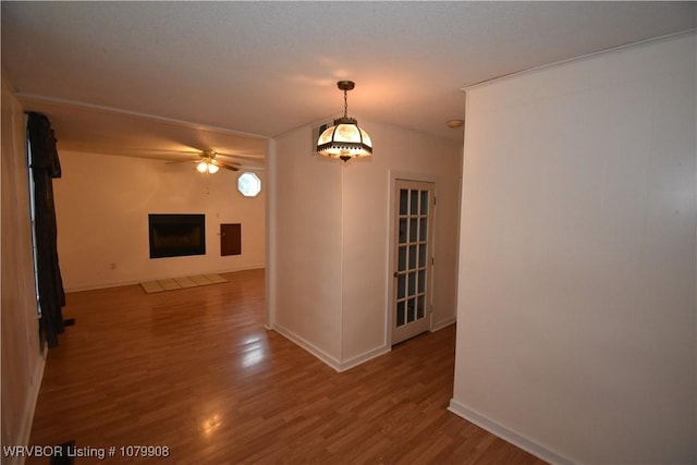 interior space featuring baseboards and wood finished floors