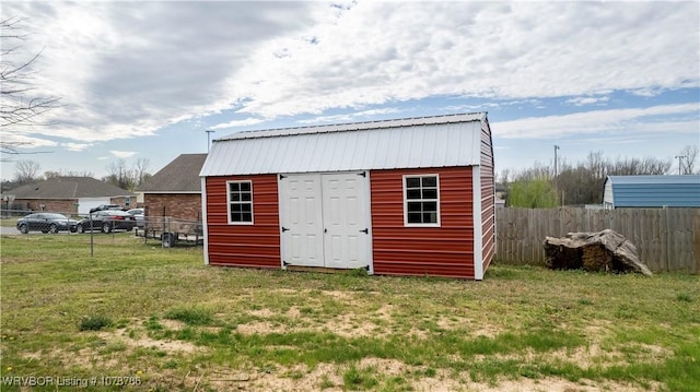 view of outbuilding with an outbuilding and fence