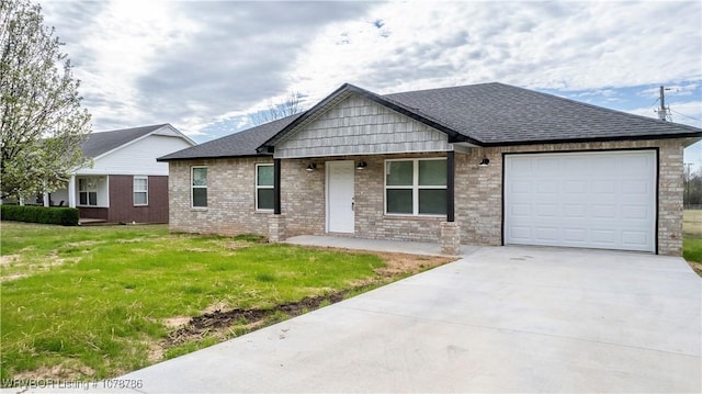 view of front facade with roof with shingles, driveway, an attached garage, and a front lawn
