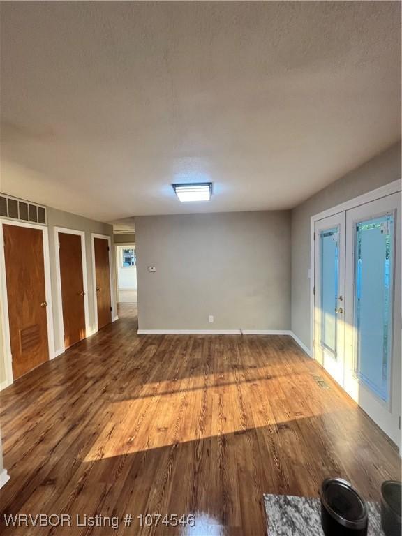 interior space with hardwood / wood-style floors and french doors