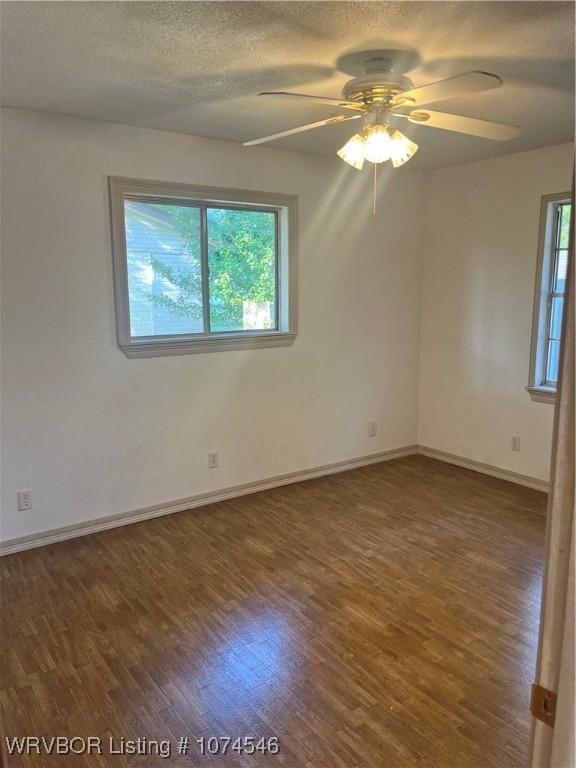 unfurnished room featuring ceiling fan and dark hardwood / wood-style floors