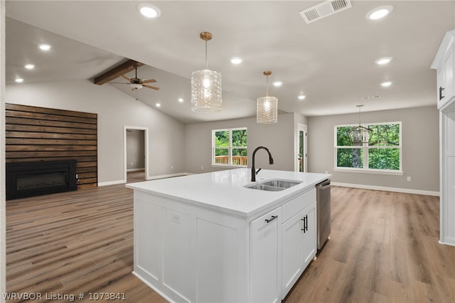 kitchen featuring white cabinetry, sink, a center island with sink, and light wood-type flooring