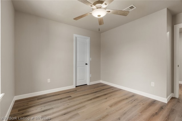 empty room with ceiling fan and light hardwood / wood-style floors