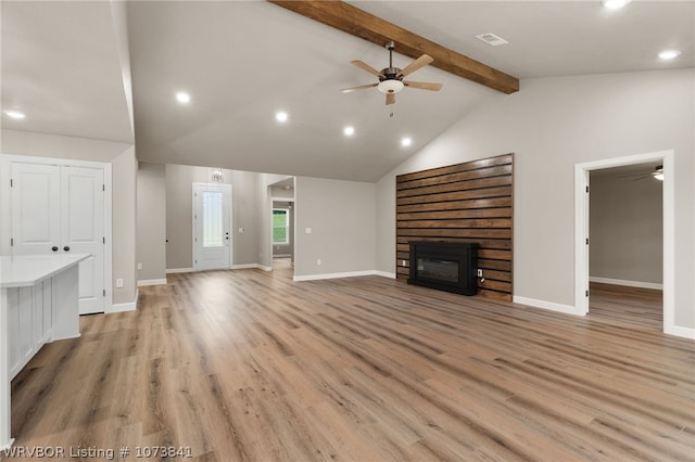 unfurnished living room with vaulted ceiling with beams, light hardwood / wood-style flooring, and ceiling fan