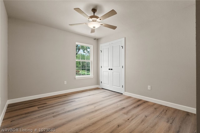 unfurnished bedroom with ceiling fan and light hardwood / wood-style floors