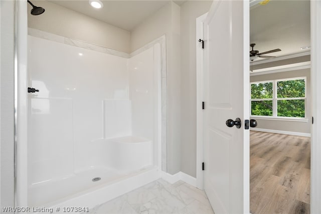 bathroom with walk in shower and ceiling fan