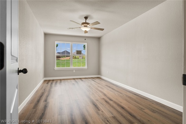 unfurnished room featuring hardwood / wood-style floors and ceiling fan