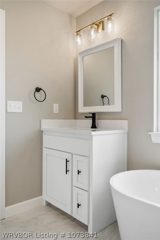 bathroom with a tub to relax in and vanity