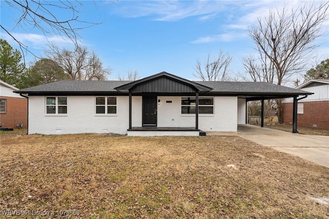 ranch-style house with a carport, covered porch, and a front lawn