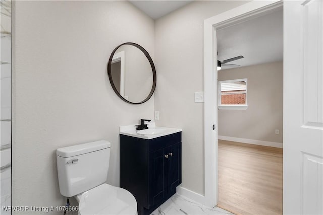 bathroom featuring vanity, ceiling fan, and toilet