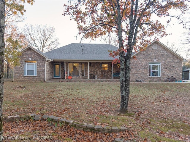 rear view of house featuring a lawn