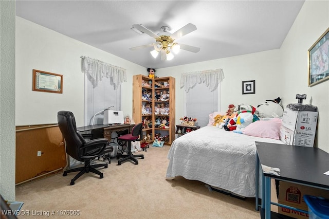 bedroom featuring ceiling fan and light carpet