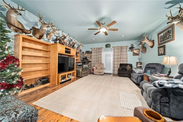 living room featuring light hardwood / wood-style flooring and ceiling fan