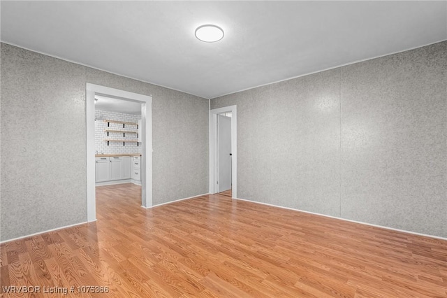 unfurnished room with light wood-type flooring