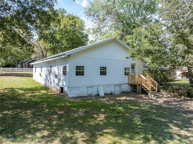 view of side of home with a lawn