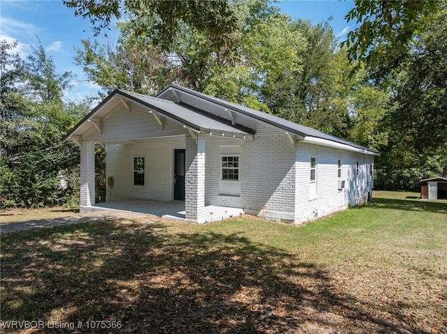 rear view of property featuring a patio area and a yard