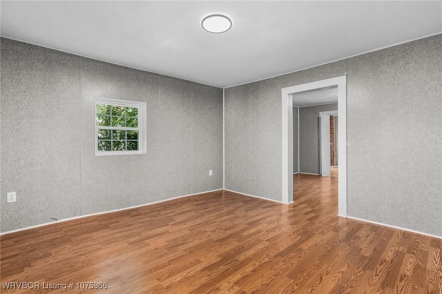 spare room with hardwood / wood-style floors