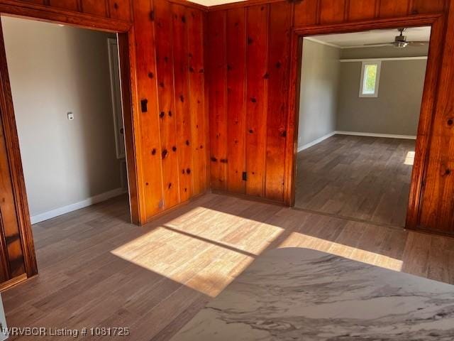 310 Butler St, Lavaca, AR 72941 - empty room featuring wood finished floors, a ceiling fan, and wooden walls