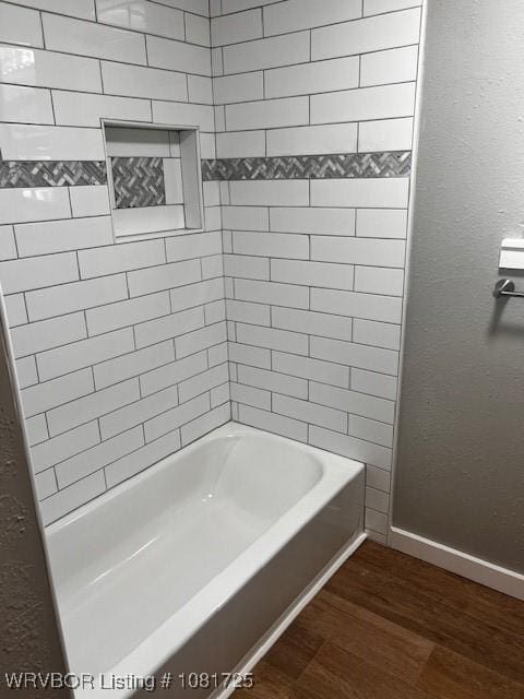 310 Butler St, Lavaca, AR 72941 - bathroom featuring wood finished floors and bathtub / shower combination