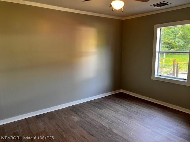 310 Butler St, Lavaca, AR 72941 - spare room featuring crown molding, ceiling fan, dark wood-style flooring, and plenty of natural light