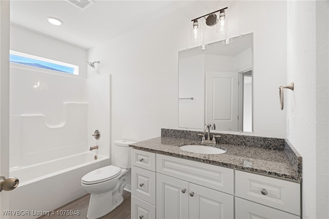 full bathroom featuring hardwood / wood-style flooring, vanity, shower / bathtub combination, and toilet