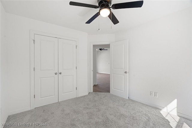 unfurnished bedroom with ceiling fan, carpet floors, and a closet