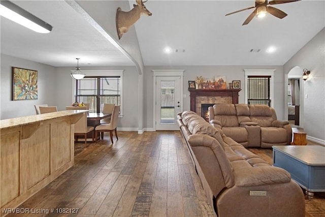 304 Rock Cir, Lavaca, AR 72941 - living area featuring arched walkways, a ceiling fan, dark wood finished floors, a fireplace, and lofted ceiling