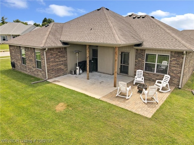 304 Rock Cir, Lavaca, AR 72941 - rear view of property featuring brick siding, a lawn, a patio, an outdoor fire pit, and a shingled roof