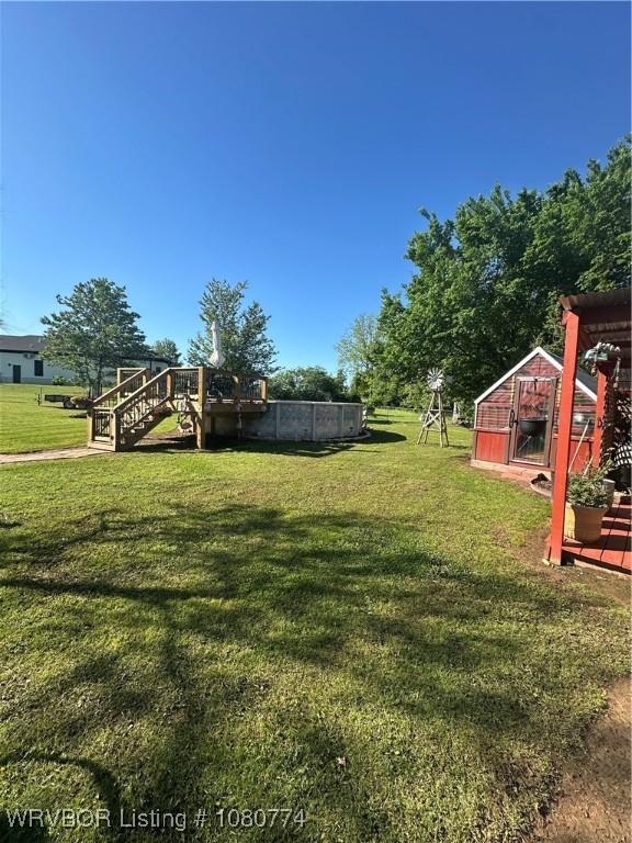 108722 4768th Rd, Roland, OK 74954 - view of yard with stairs, an outbuilding, a shed, and a deck