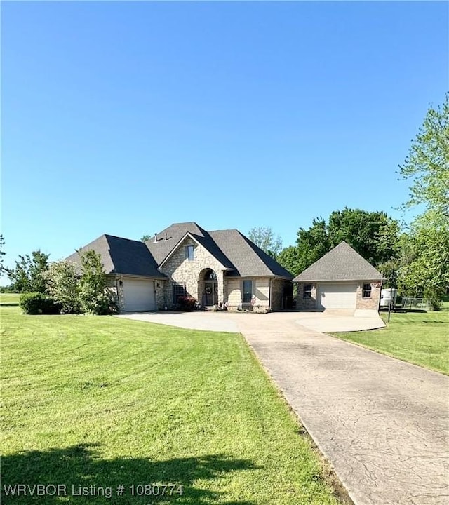 108722 4768th Rd, Roland, OK 74954 - view of front of home with stone siding, a front lawn, driveway, and an attached garage