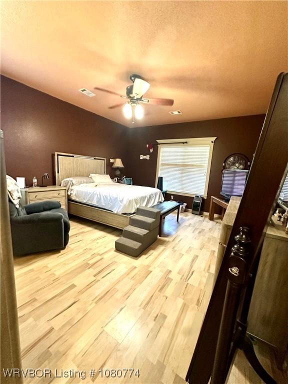 108722 4768th Rd, Roland, OK 74954 - bedroom featuring ceiling fan, visible vents, and wood finished floors