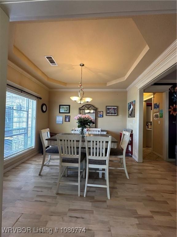 108722 4768th Rd, Roland, OK 74954 - dining area featuring a tray ceiling, visible vents, light wood-style flooring, and ornamental molding
