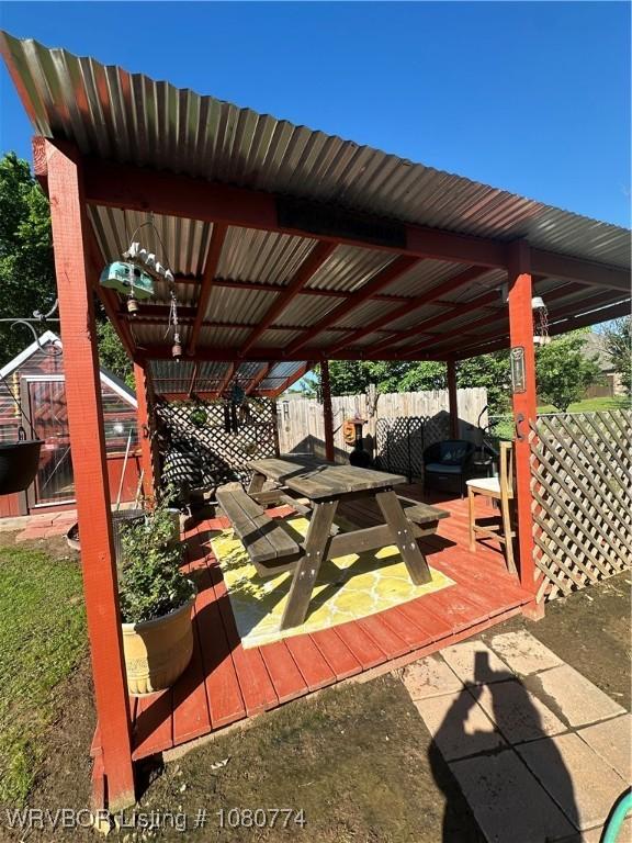 108722 4768th Rd, Roland, OK 74954 - view of patio featuring fence, an outbuilding, and a deck