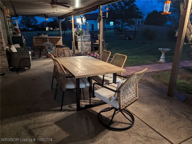 108722 4768th Rd, Roland, OK 74954 - patio at night featuring a hot tub, ceiling fan, and outdoor dining space