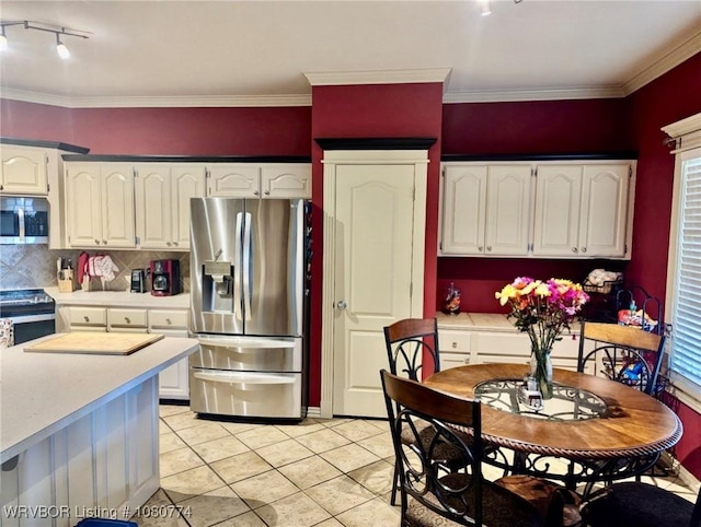 108722 4768th Rd, Roland, OK 74954 - kitchen featuring appliances with stainless steel finishes, light countertops, light tile patterned floors, white cabinetry, and decorative backsplash