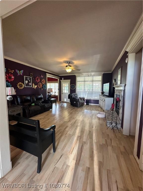 108722 4768th Rd, Roland, OK 74954 - living area featuring ceiling fan, ornamental molding, light wood-type flooring, and plenty of natural light