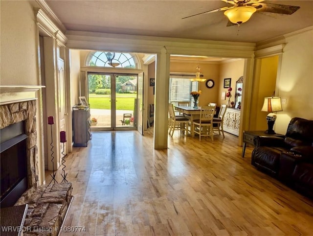 108722 4768th Rd, Roland, OK 74954 - living area featuring ornamental molding, a fireplace, wood finished floors, ceiling fan, and healthy amount of natural light