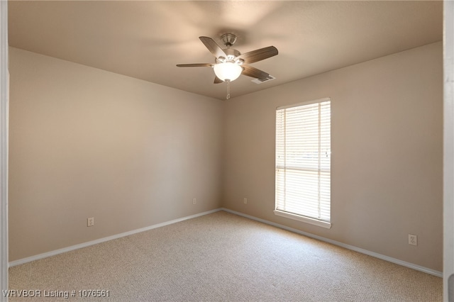 carpeted empty room featuring ceiling fan