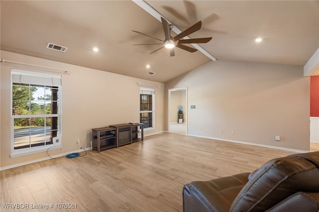 living room with vaulted ceiling with beams, ceiling fan, and light wood-type flooring