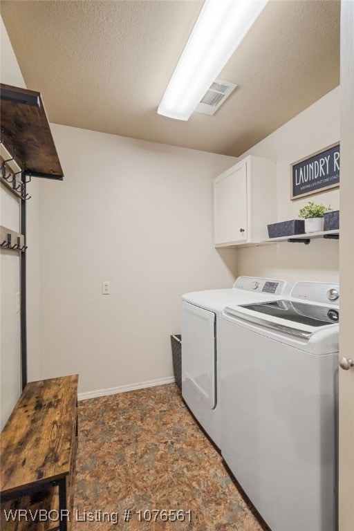 clothes washing area featuring cabinets, independent washer and dryer, and a textured ceiling