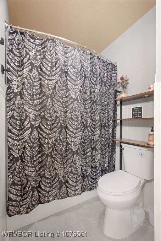 bathroom with tile patterned flooring and toilet