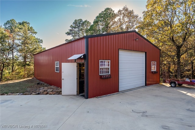 view of garage at dusk