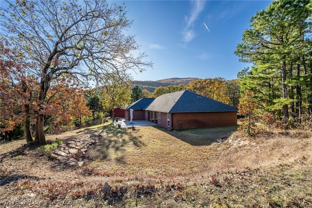 view of side of property featuring a patio area