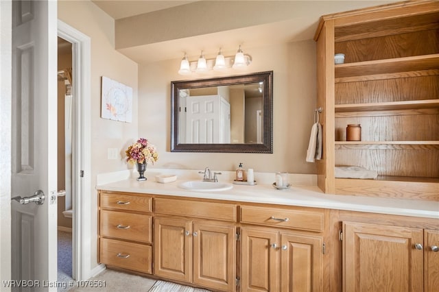 bathroom featuring tile patterned flooring, vanity, and toilet