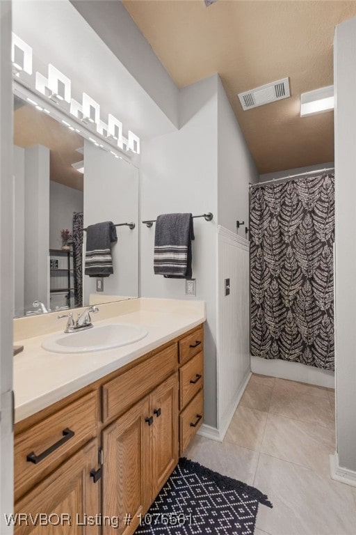 bathroom with vanity, tile patterned floors, and curtained shower