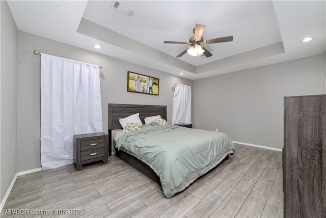 138 Stone Dr, Roland, OK 74954 - bedroom featuring wood tiled floor, visible vents, baseboards, and a raised ceiling